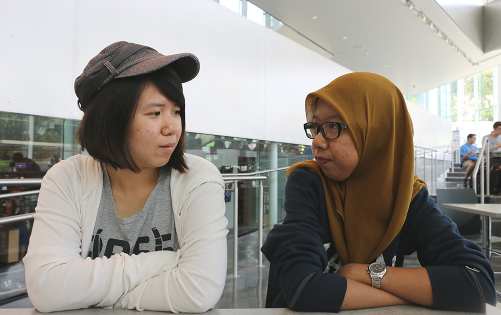 Elaine Cheah, left, and Nazirah Mohd, right, talk during lunch at the DeBruce Center. They got together for a quick lunch last Friday.